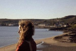 Lady with long hair looking out to sea